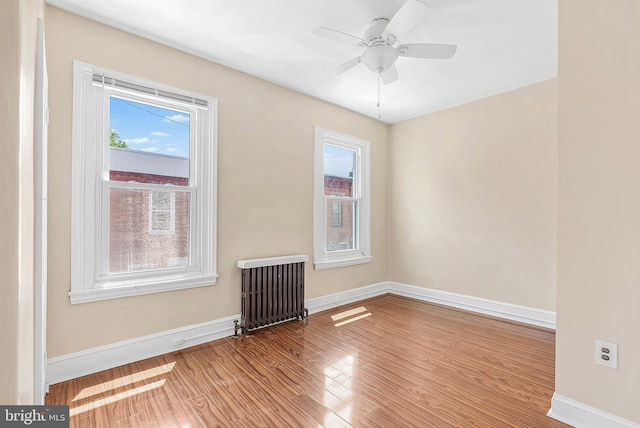 159 W Palmer St, Philadelphia, PA 19122 - empty room featuring radiator heating unit, healthy amount of natural light, baseboards, and wood finished floors