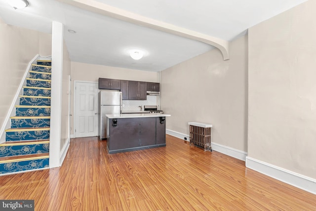 159 W Palmer St, Philadelphia, PA 19122 - kitchen featuring freestanding refrigerator, dark brown cabinets, light wood-type flooring, and light countertops