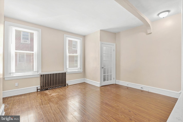 159 W Palmer St, Philadelphia, PA 19122 - empty room with radiator heating unit, baseboards, and wood finished floors