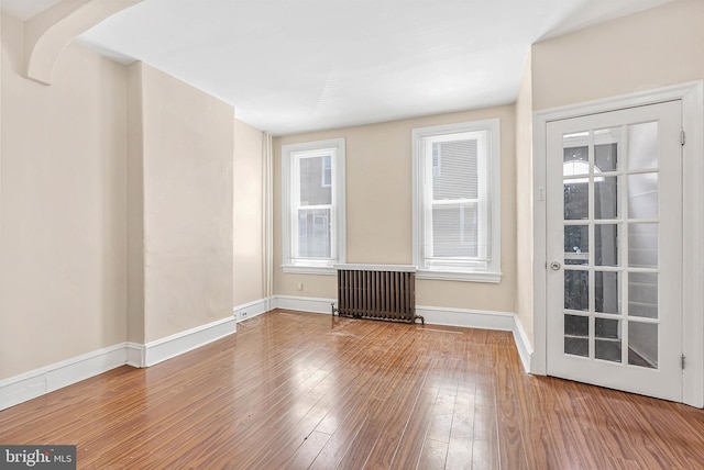159 W Palmer St, Philadelphia, PA 19122 - spare room with radiator, wood-type flooring, and baseboards