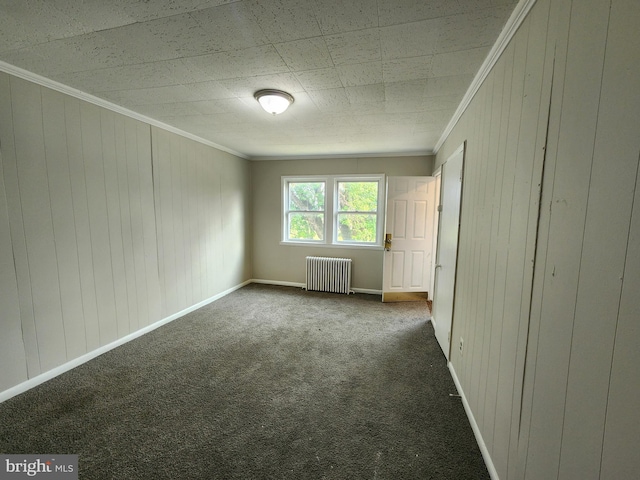 1609 Spruce St, Baltimore City, MD 21226 - empty room featuring radiator, crown molding, dark colored carpet, baseboards, and wood walls
