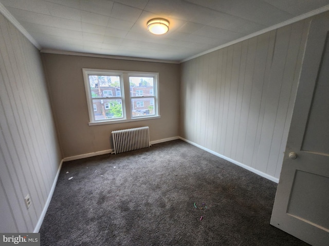 1609 Spruce St, Baltimore City, MD 21226 - spare room featuring radiator, crown molding, carpet floors, baseboards, and wooden walls