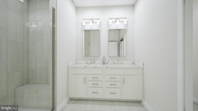 23640 Bolton Crescent Ter Unit 13-306, Ashburn, VA 20148 - bathroom featuring a stall shower, baseboards, and double vanity