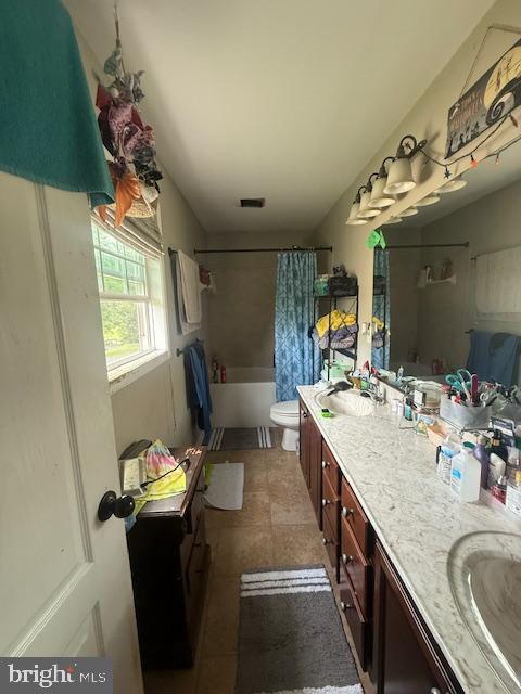 453 Kirby Ave, Waynesboro, VA 22980 - bathroom featuring double vanity, shower / bath combo with shower curtain, and tile patterned flooring