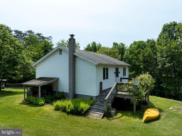 10496 Red Hawk Ln, Huntingdon, PA 16652 - rear view of house with a chimney, a lawn, and stairway