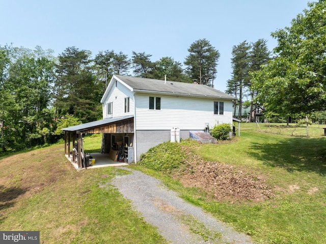 10496 Red Hawk Ln, Huntingdon, PA 16652 - view of side of property with driveway, a carport, and a lawn