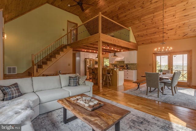 2020 Quaint Acres Ln, Berkeley Springs, WV 25411 - living area with high vaulted ceiling, a chandelier, stairway, light wood-style flooring, and a ceiling fan