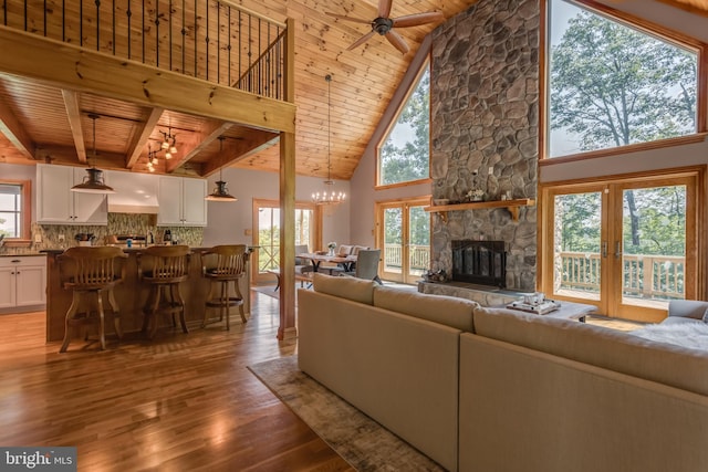 2020 Quaint Acres Ln, Berkeley Springs, WV 25411 - living area with wood ceiling with exposed beams, wood finished floors, healthy amount of natural light, a fireplace, and high vaulted ceiling