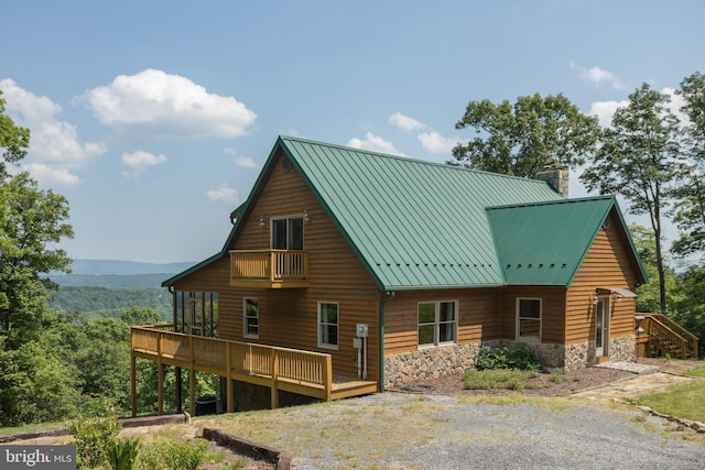 2020 Quaint Acres Ln, Berkeley Springs, WV 25411 - rear view of house with a chimney, stone siding, a deck, and metal roof