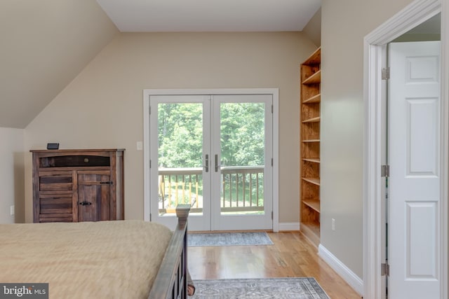 2020 Quaint Acres Ln, Berkeley Springs, WV 25411 - bedroom with french doors, access to exterior, light wood finished floors, multiple windows, and lofted ceiling