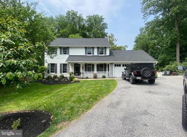 265 Hunters Ridge Rd, Lutherville Timonium, MD 21093 - view of front facade featuring covered porch, an attached garage, asphalt driveway, a front lawn, and roof with shingles
