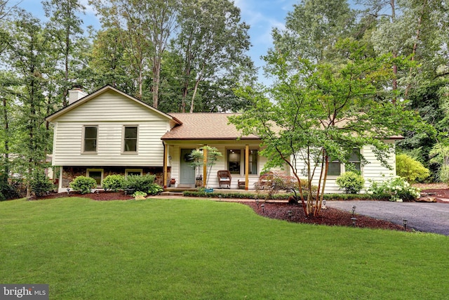 8170 Sinclair Mill Rd, Manassas, VA 20112 - split level home featuring covered porch, a front lawn, and a chimney
