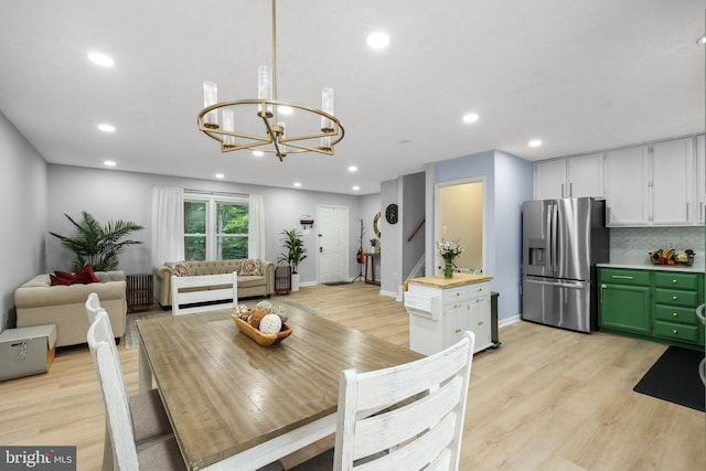 8170 Sinclair Mill Rd, Manassas, VA 20112 - dining room featuring a chandelier, light wood-type flooring, recessed lighting, baseboards, and stairs