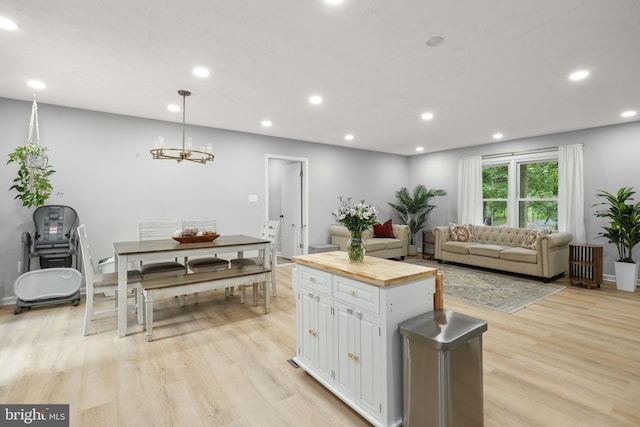 8170 Sinclair Mill Rd, Manassas, VA 20112 - kitchen with wooden counters, white cabinetry, light wood-type flooring, recessed lighting, and a kitchen island