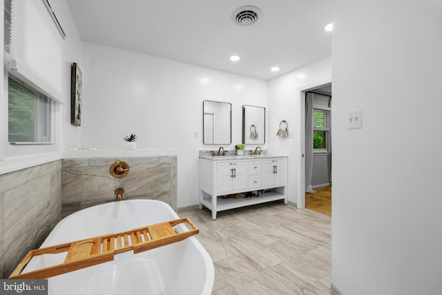 8170 Sinclair Mill Rd, Manassas, VA 20112 - bathroom featuring double vanity, a soaking tub, marble finish floors, and recessed lighting