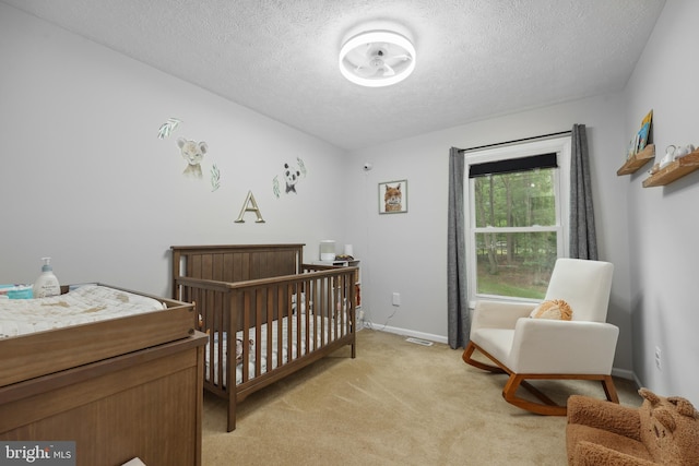 8170 Sinclair Mill Rd, Manassas, VA 20112 - bedroom featuring a textured ceiling, light carpet, a nursery area, and baseboards