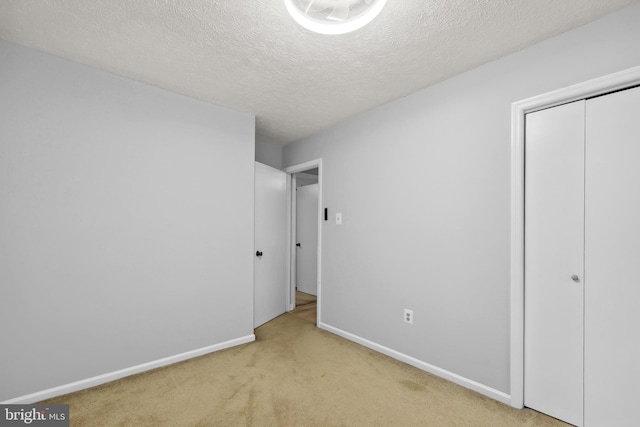 8170 Sinclair Mill Rd, Manassas, VA 20112 - unfurnished bedroom with carpet, baseboards, a closet, and a textured ceiling