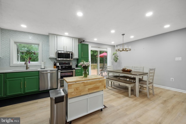 8170 Sinclair Mill Rd, Manassas, VA 20112 - kitchen with stainless steel appliances, green cabinets, a sink, recessed lighting, and tasteful backsplash