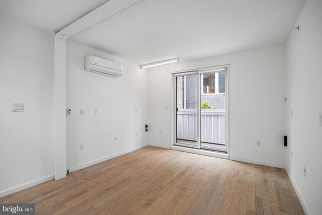 2710 W Harper St, Philadelphia, PA 19130 - spare room featuring a wall unit AC and light wood-style flooring