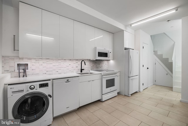 2710 W Harper St, Philadelphia, PA 19130 - kitchen featuring white appliances, washer / clothes dryer, decorative backsplash, white cabinetry, and light countertops