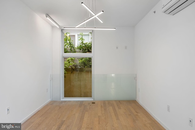 2710 W Harper St, Philadelphia, PA 19130 - spare room featuring a wall mounted air conditioner and wood finished floors