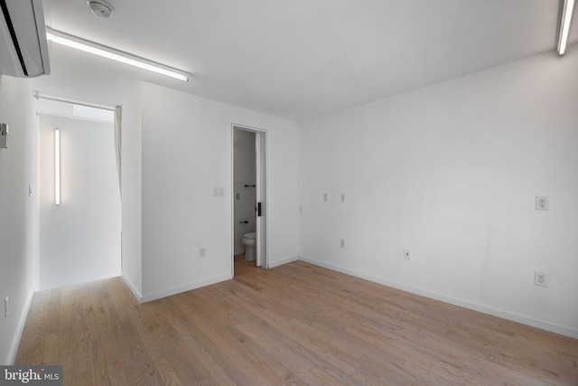 2710 W Harper St, Philadelphia, PA 19130 - spare room featuring light wood-style floors, a smoke detector, and a wall unit AC