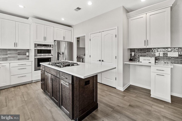 202 Galyn Dr, Brunswick, MD 21758 - kitchen featuring stainless steel appliances, light countertops, white cabinets, recessed lighting, and backsplash