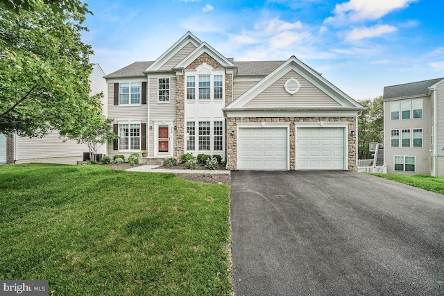 202 Galyn Dr, Brunswick, MD 21758 - view of front of home featuring stone siding, driveway, a front yard, and a garage