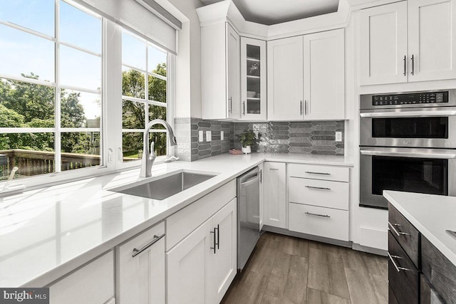 202 Galyn Dr, Brunswick, MD 21758 - kitchen featuring stainless steel appliances, a sink, white cabinetry, decorative backsplash, and wood finished floors