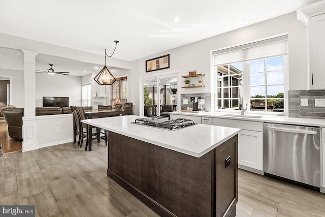 202 Galyn Dr, Brunswick, MD 21758 - kitchen with appliances with stainless steel finishes, tasteful backsplash, a center island, white cabinets, and ornate columns