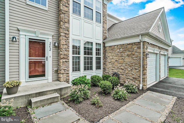 202 Galyn Dr, Brunswick, MD 21758 - entrance to property with stone siding, a shingled roof, a garage, and asphalt driveway