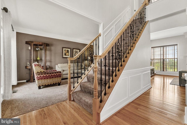 202 Galyn Dr, Brunswick, MD 21758 - stairs with wood finished floors, a decorative wall, wainscoting, and crown molding