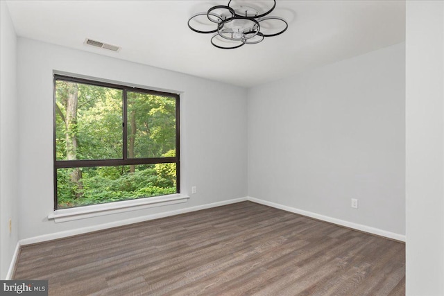 1701 Gainesville St SE Unit 101, Washington, DC 20020 - empty room with a chandelier, wood finished floors, and baseboards