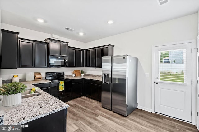 17324 Mary Adams Ave, Bowling Green, VA 22427 - kitchen featuring black appliances, dark cabinets, light wood-style flooring, light stone counters, and recessed lighting