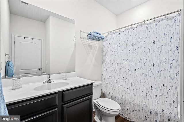 17324 Mary Adams Ave, Bowling Green, VA 22427 - bathroom with toilet, vanity, wood finished floors, and curtained shower