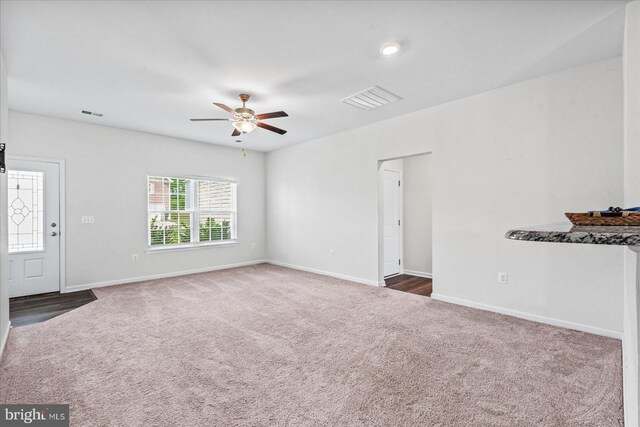 17324 Mary Adams Ave, Bowling Green, VA 22427 - unfurnished living room with carpet floors, a ceiling fan, and baseboards