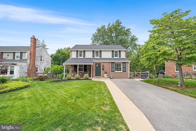 142 Barcladen Rd, Bryn Mawr, PA 19010 - traditional-style house with brick siding, asphalt driveway, and a porch