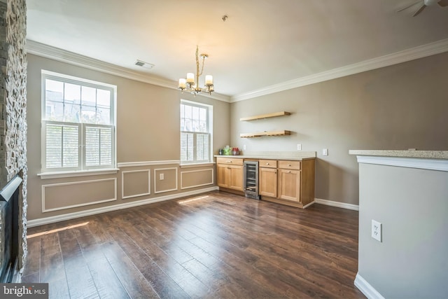 305 S Payne St Unit 305, Alexandria, VA 22314 - unfurnished dining area featuring wine cooler, dark wood finished floors, a dry bar, ornamental molding, and a chandelier