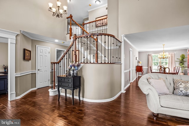4170 Tersher Dr, Doylestown, PA 18902 - living room with a chandelier, a towering ceiling, stairs, wood-type flooring, and ornamental molding