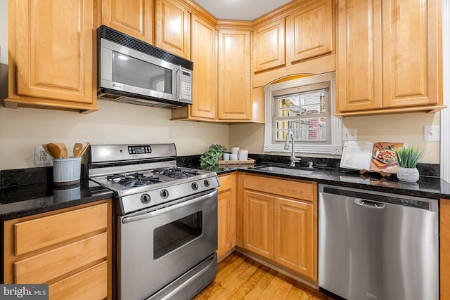 234 E Barney St E, Baltimore, MD 21230 - kitchen featuring stainless steel appliances, a sink, light wood-type flooring, and dark stone counters