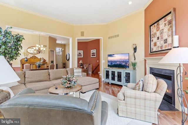 6 Easton Ln, Cinnaminson, NJ 08077 - living area with a chandelier, wood finished floors, ornamental molding, a glass covered fireplace, and baseboards