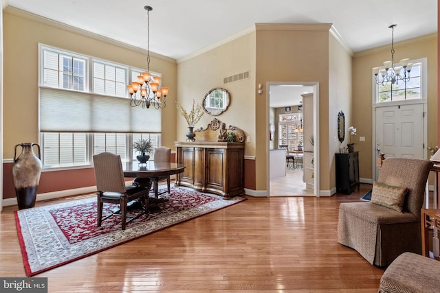 6 Easton Ln, Cinnaminson, NJ 08077 - dining space featuring a chandelier, light wood-style flooring, a high ceiling, baseboards, and ornamental molding