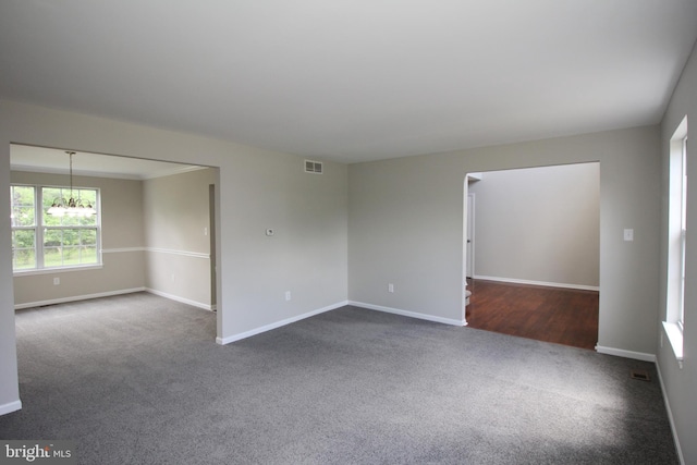 7 E Edgewater Ct, Sicklerville, NJ 08081 - empty room with dark carpet, baseboards, and a chandelier