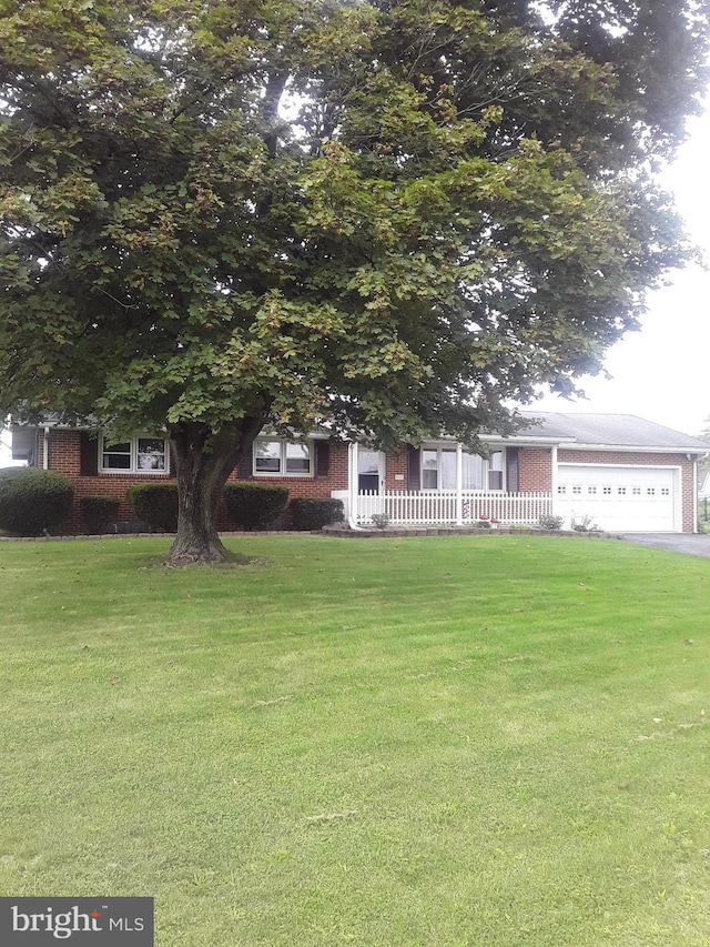 28 Kough Rd, Newville, PA 17241 - obstructed view of property with a front lawn, a garage, brick siding, and driveway