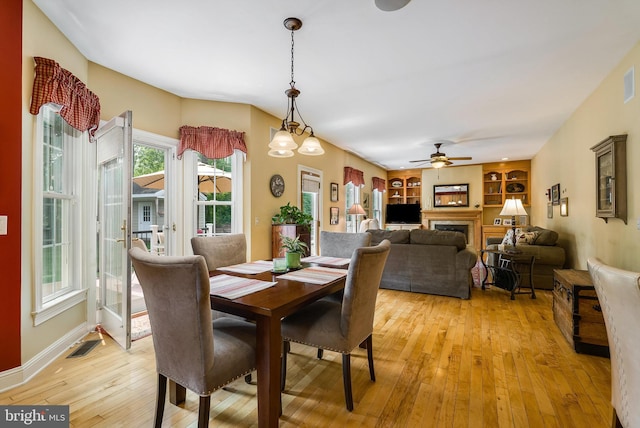3525 Traveler Rd, Rockingham, VA 22801 - dining space featuring light wood finished floors, ceiling fan, a fireplace, and built in features