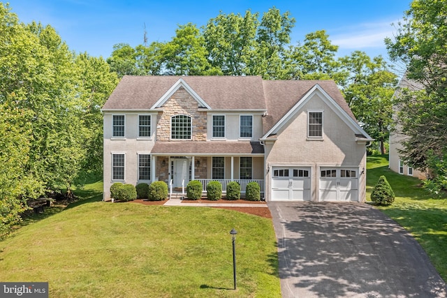 106 Gabrielle Ct Unit 8, Broomall, PA 19008 - view of front facade with stone siding, driveway, covered porch, a garage, and a front yard