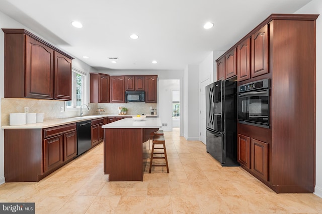 106 Gabrielle Ct Unit 8, Broomall, PA 19008 - kitchen with black appliances, a kitchen bar, backsplash, recessed lighting, and a sink