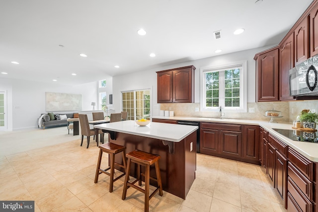 106 Gabrielle Ct Unit 8, Broomall, PA 19008 - kitchen featuring black appliances, recessed lighting, a kitchen island, decorative backsplash, and light countertops