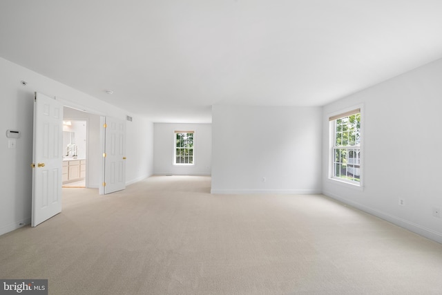106 Gabrielle Ct Unit 8, Broomall, PA 19008 - spare room featuring healthy amount of natural light, light carpet, and baseboards