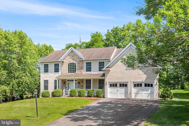 106 Gabrielle Ct Unit 8, Broomall, PA 19008 - view of front of property with stone siding, driveway, covered porch, and a front lawn